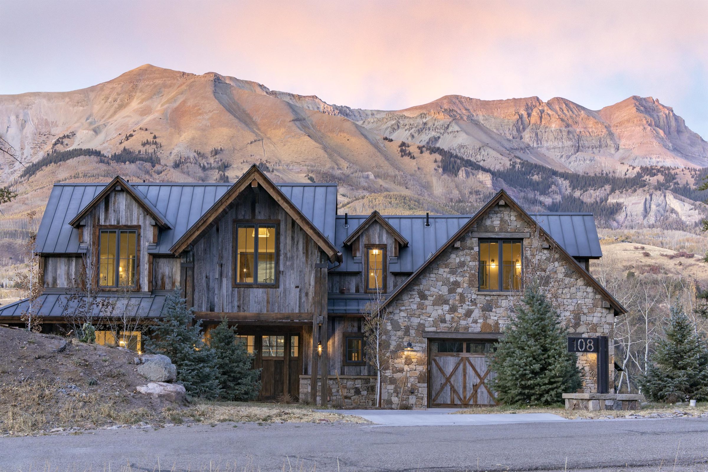 Custom mountain home at 108 Lawson Overlook, built by UltraBuilders in Mountain Village, Colorado, at dusk